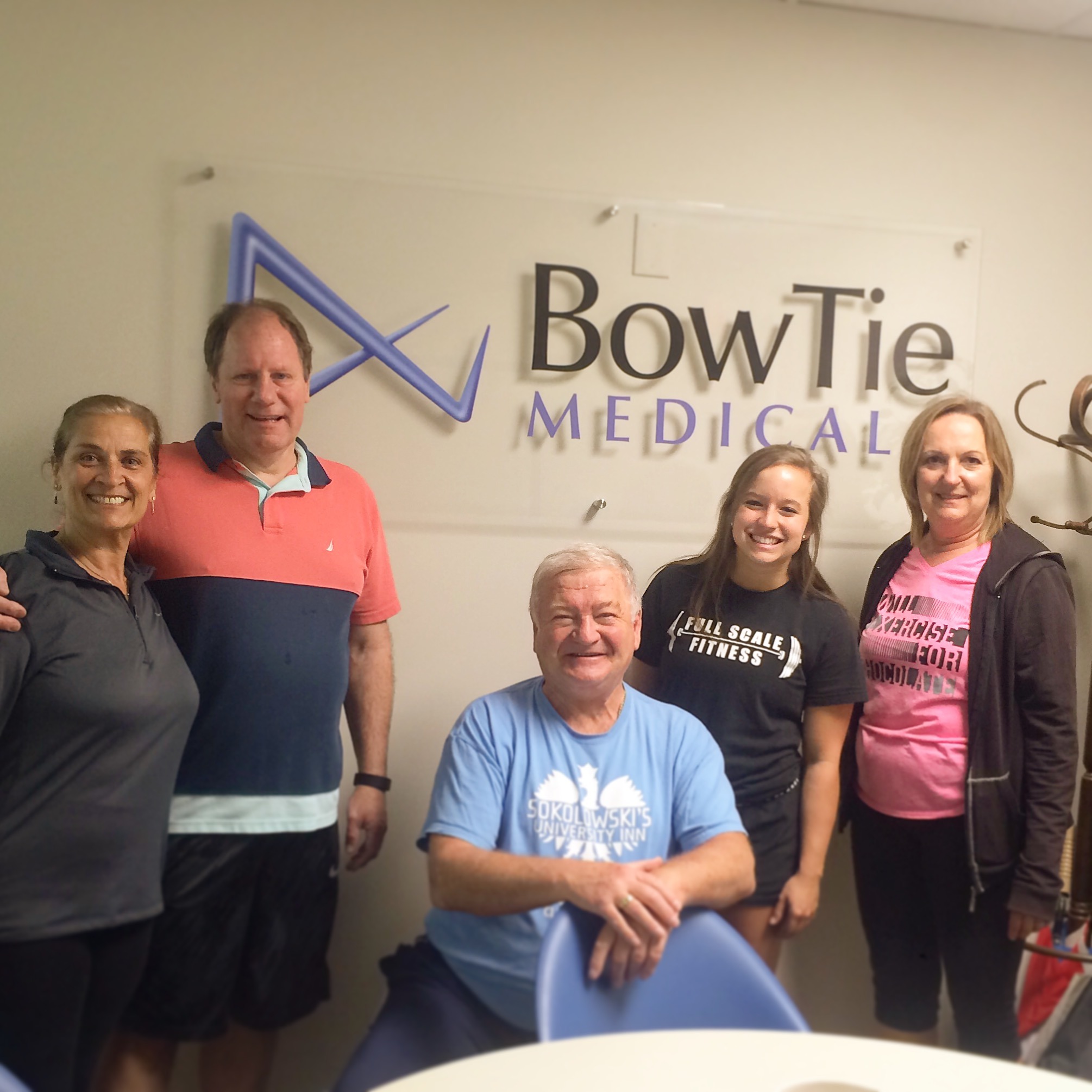 Full Scale Fitness trainer and BowTie Medical employees smiling after an on-site corporate wellness group training class in Akron, Ohio