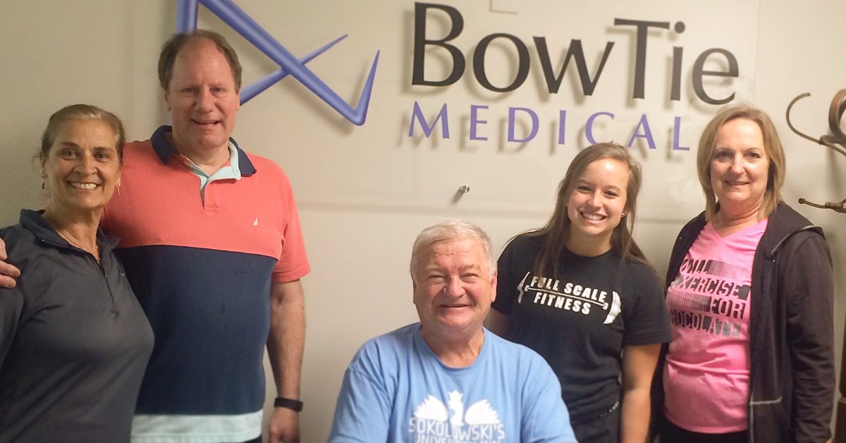Full Scale Fitness trainer and BowTie Medical employees smiling after an on-site corporate wellness group training class in Akron, Ohio